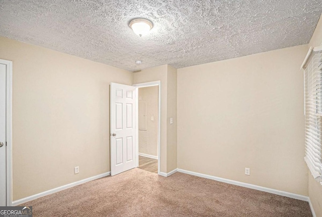 unfurnished bedroom featuring carpet floors and a textured ceiling