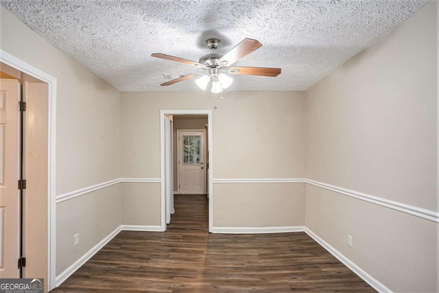 spare room featuring ceiling fan, dark hardwood / wood-style flooring, and a textured ceiling