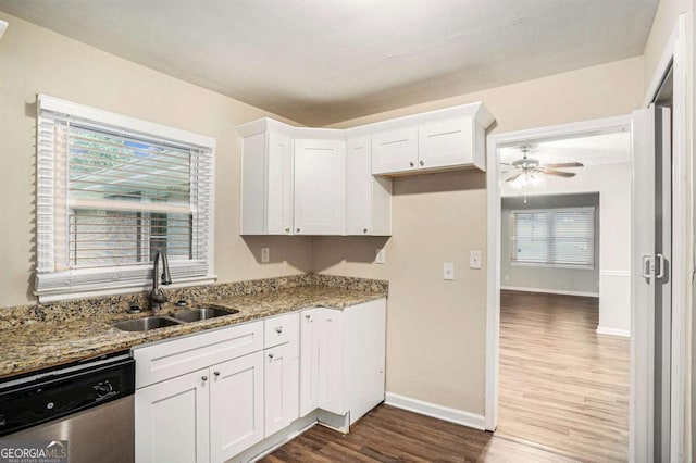 kitchen featuring dark hardwood / wood-style flooring, white cabinetry, stainless steel dishwasher, and sink