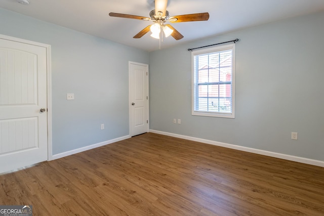 unfurnished room featuring hardwood / wood-style floors and ceiling fan