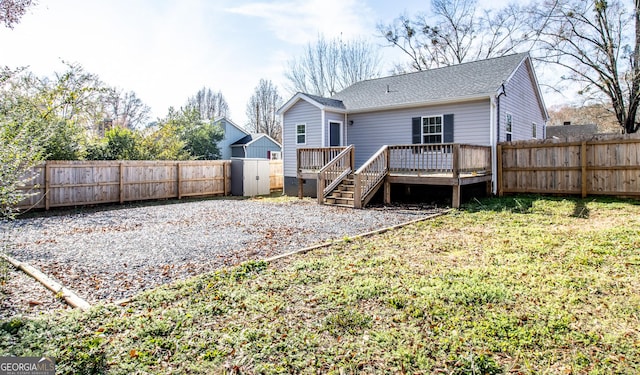 back of house with a deck