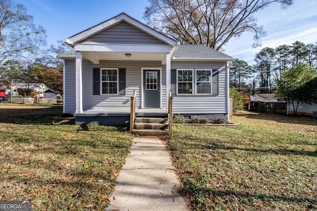 bungalow-style house featuring a front yard