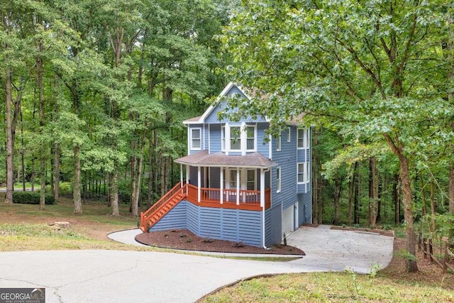 view of front of home with covered porch and a garage