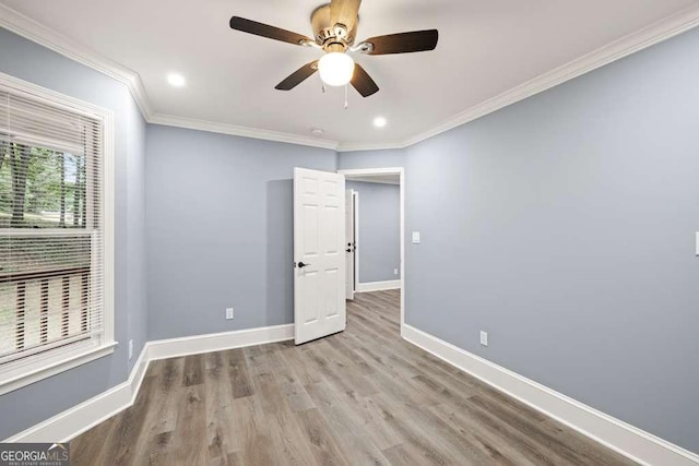 spare room featuring ceiling fan, ornamental molding, and light hardwood / wood-style flooring