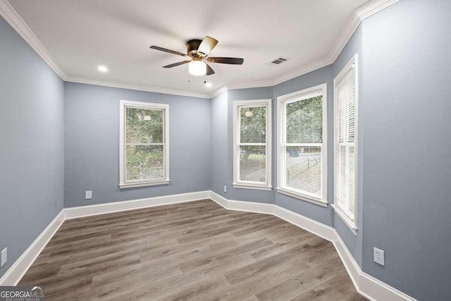 spare room featuring hardwood / wood-style flooring, ceiling fan, and ornamental molding