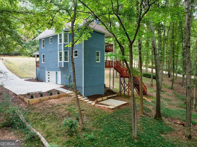 back of house featuring a deck and a garage