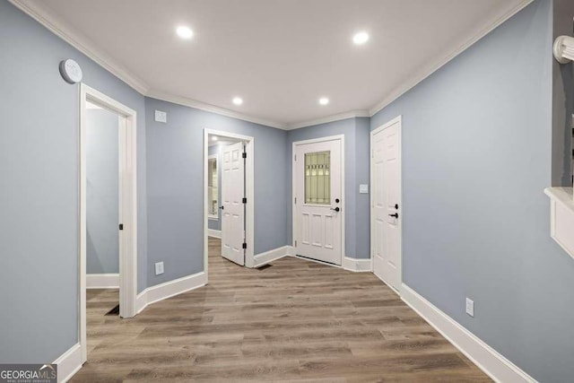 foyer with light hardwood / wood-style flooring and ornamental molding