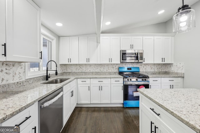 kitchen featuring white cabinets, sink, hanging light fixtures, tasteful backsplash, and stainless steel appliances