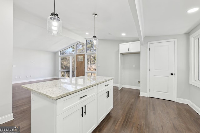 kitchen with a center island, white cabinets, hanging light fixtures, vaulted ceiling with beams, and light stone countertops