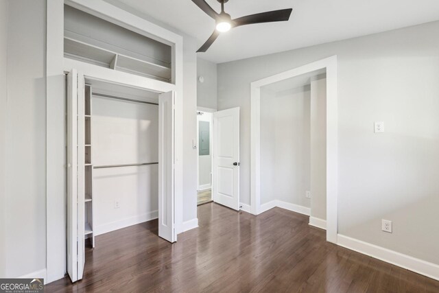 unfurnished bedroom with ceiling fan and dark hardwood / wood-style flooring