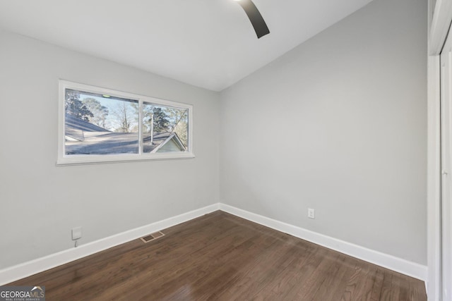 unfurnished room featuring ceiling fan, dark hardwood / wood-style floors, and lofted ceiling