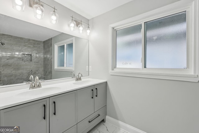 bathroom featuring a shower and vanity