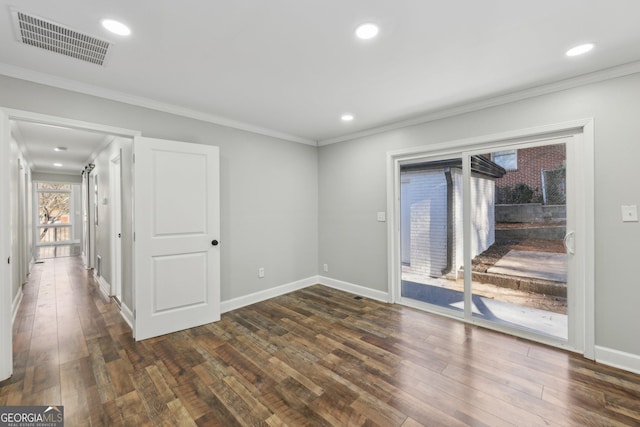 unfurnished room with ornamental molding and dark wood-type flooring