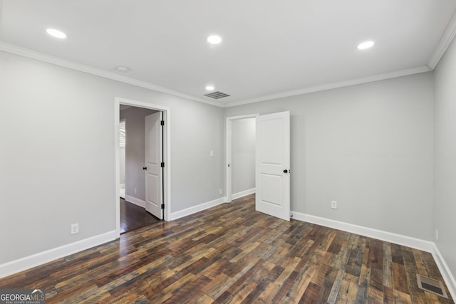 spare room featuring crown molding and dark wood-type flooring