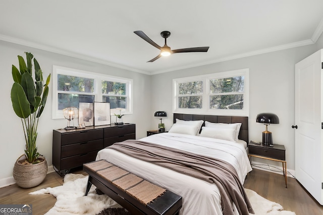 bedroom featuring ceiling fan, hardwood / wood-style floors, and crown molding