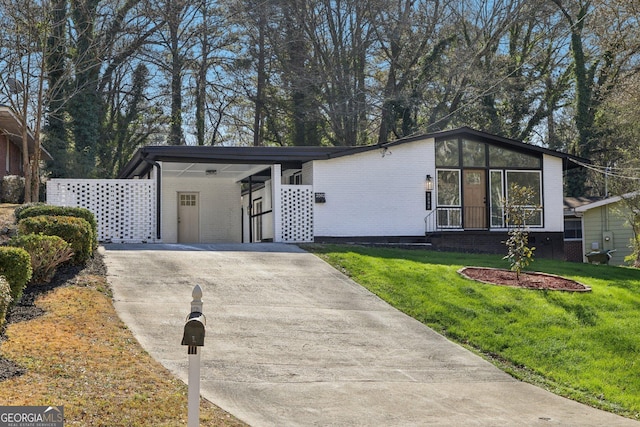 view of front of property with a front lawn and a carport