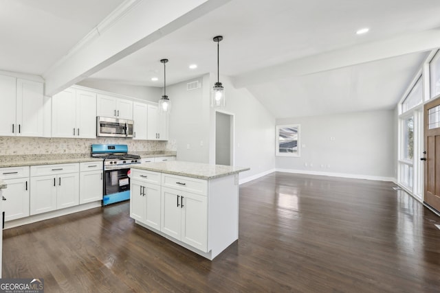 kitchen with light stone counters, stainless steel appliances, lofted ceiling with beams, decorative light fixtures, and white cabinets