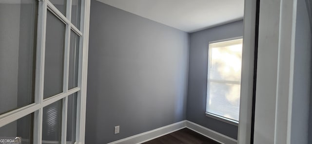 empty room with dark hardwood / wood-style floors