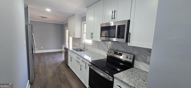 kitchen featuring sink, dark hardwood / wood-style flooring, crown molding, white cabinets, and appliances with stainless steel finishes