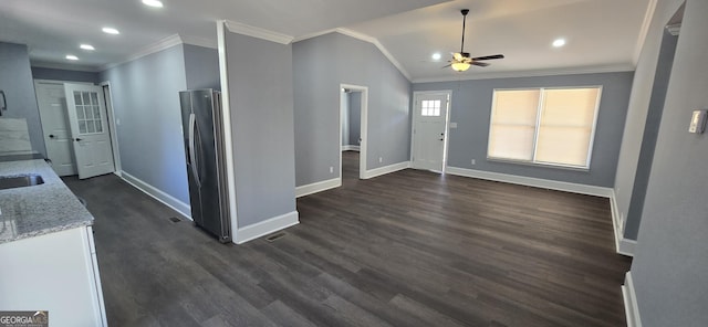 entryway featuring ceiling fan, crown molding, dark wood-type flooring, and vaulted ceiling