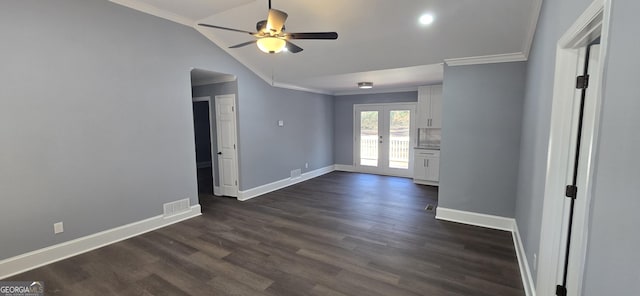 empty room featuring french doors, dark hardwood / wood-style flooring, ornamental molding, ceiling fan, and lofted ceiling