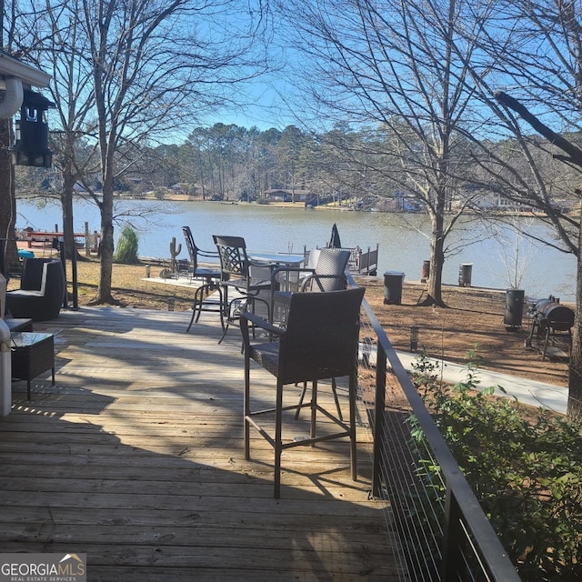 wooden terrace featuring a water view