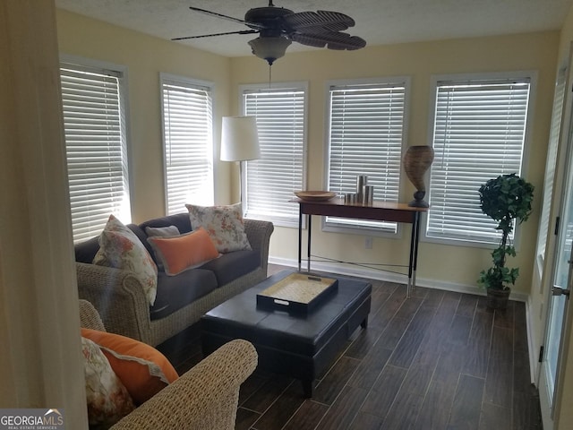 living room featuring ceiling fan and dark hardwood / wood-style flooring