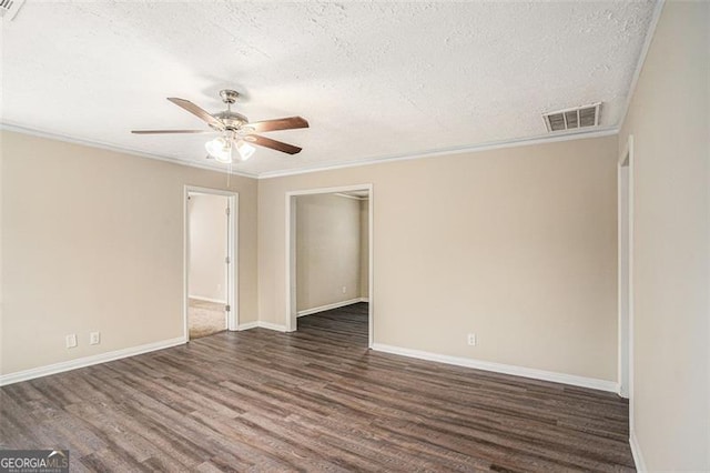 spare room with a textured ceiling, ceiling fan, dark hardwood / wood-style floors, and ornamental molding