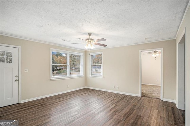 interior space with a textured ceiling, crown molding, ceiling fan, and dark wood-type flooring