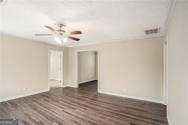 spare room featuring a textured ceiling, ceiling fan, ornamental molding, and dark wood-type flooring