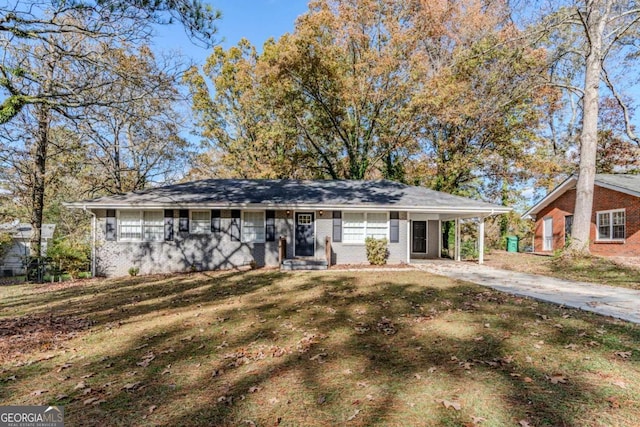 ranch-style home featuring a front yard and a carport