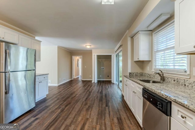 kitchen with white cabinets, appliances with stainless steel finishes, dark wood-type flooring, and sink