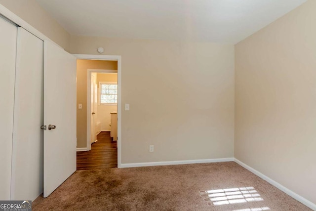 unfurnished bedroom featuring carpet and a closet