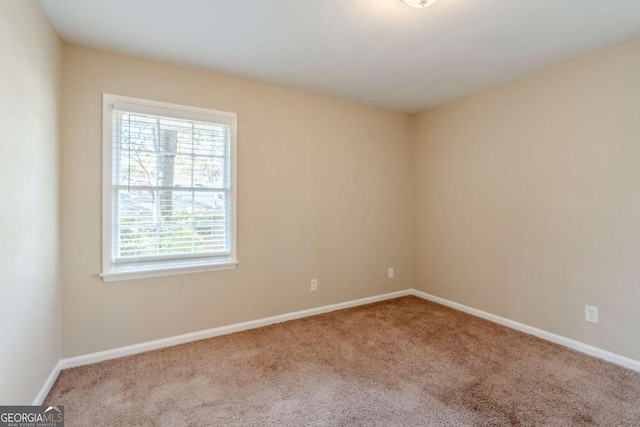 unfurnished room with light carpet