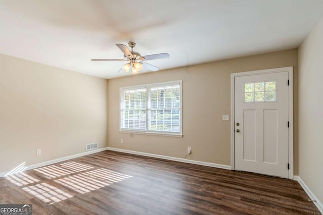 entryway featuring ceiling fan, a healthy amount of sunlight, and dark wood-type flooring