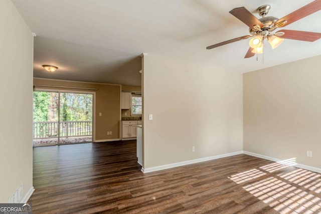 empty room featuring ceiling fan and dark wood-type flooring