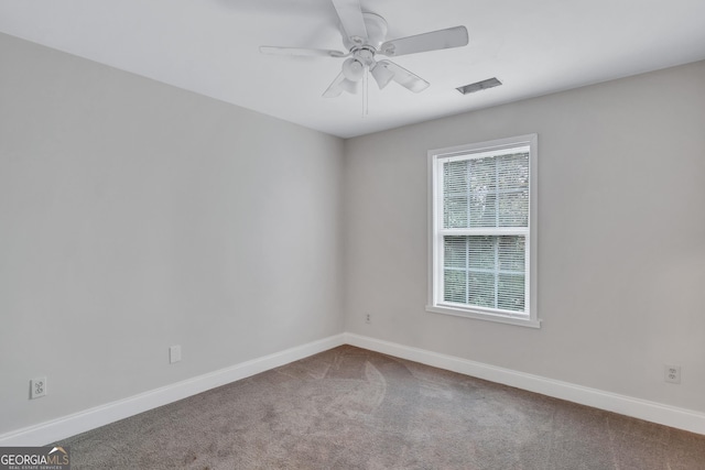 carpeted spare room with ceiling fan