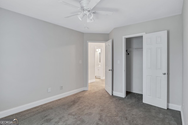 unfurnished bedroom featuring dark colored carpet, a closet, and ceiling fan