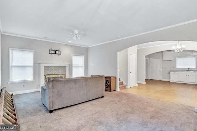 unfurnished living room featuring plenty of natural light, light colored carpet, and a tile fireplace