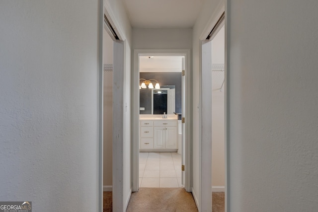 hall with light carpet and sink