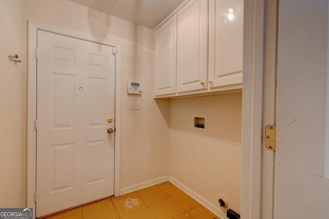 washroom featuring light tile patterned floors, cabinets, and washer hookup