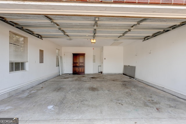 garage with a garage door opener and electric panel