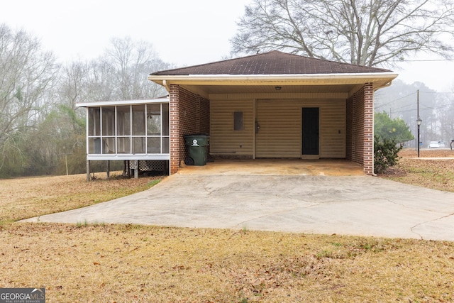 view of front of home featuring a carport and a sunroom