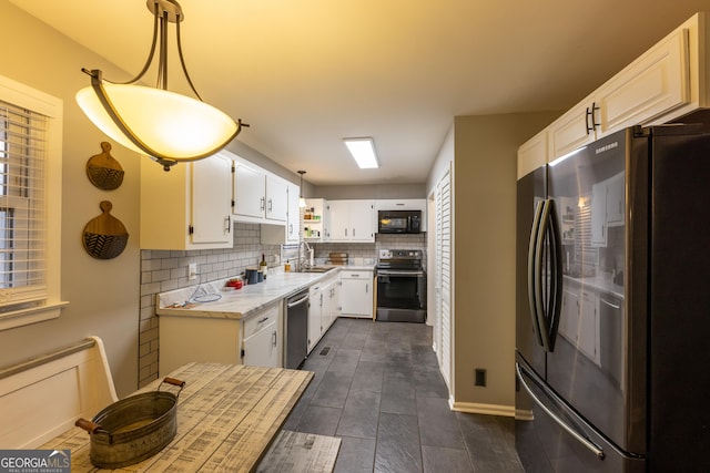 kitchen featuring pendant lighting, white cabinetry, sink, decorative backsplash, and stainless steel appliances