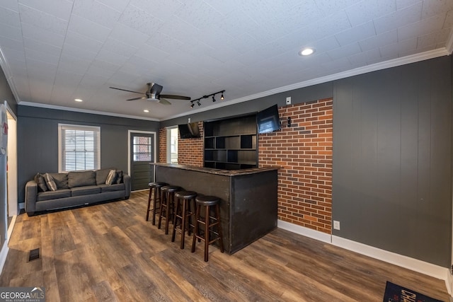 bar with ceiling fan, ornamental molding, and dark hardwood / wood-style floors