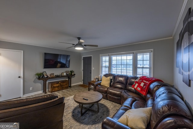 living room featuring ornamental molding, wood-type flooring, and ceiling fan