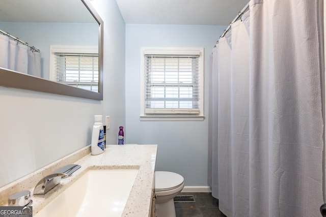 bathroom featuring a shower with curtain, vanity, and toilet