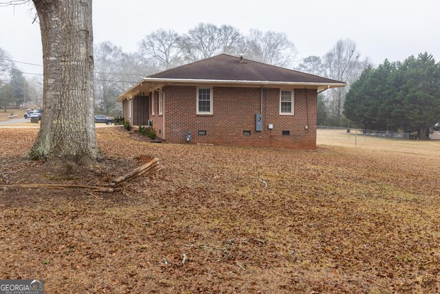 rear view of property with a sunroom, central AC unit, and a lawn