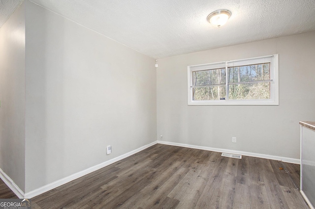 1471 Cedar Creek Ln, Riverdale, GA 30296 - empty room with wood finished floors and a textured ceiling
