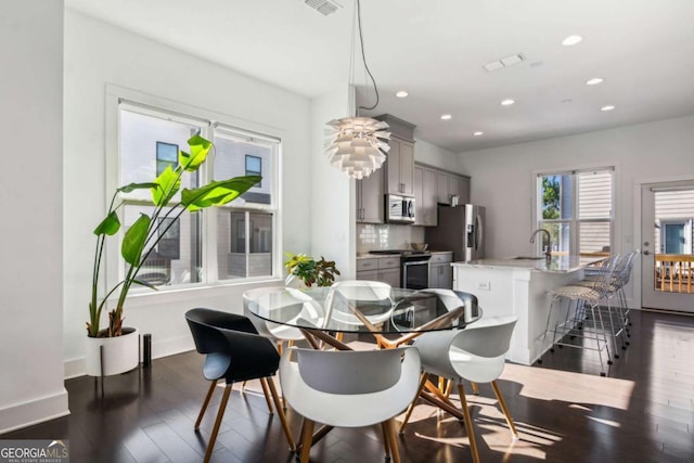 dining space featuring dark hardwood / wood-style floors and sink